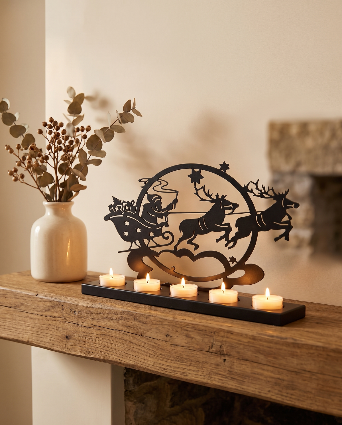Santa sleigh tealight holder on a wooden mantel