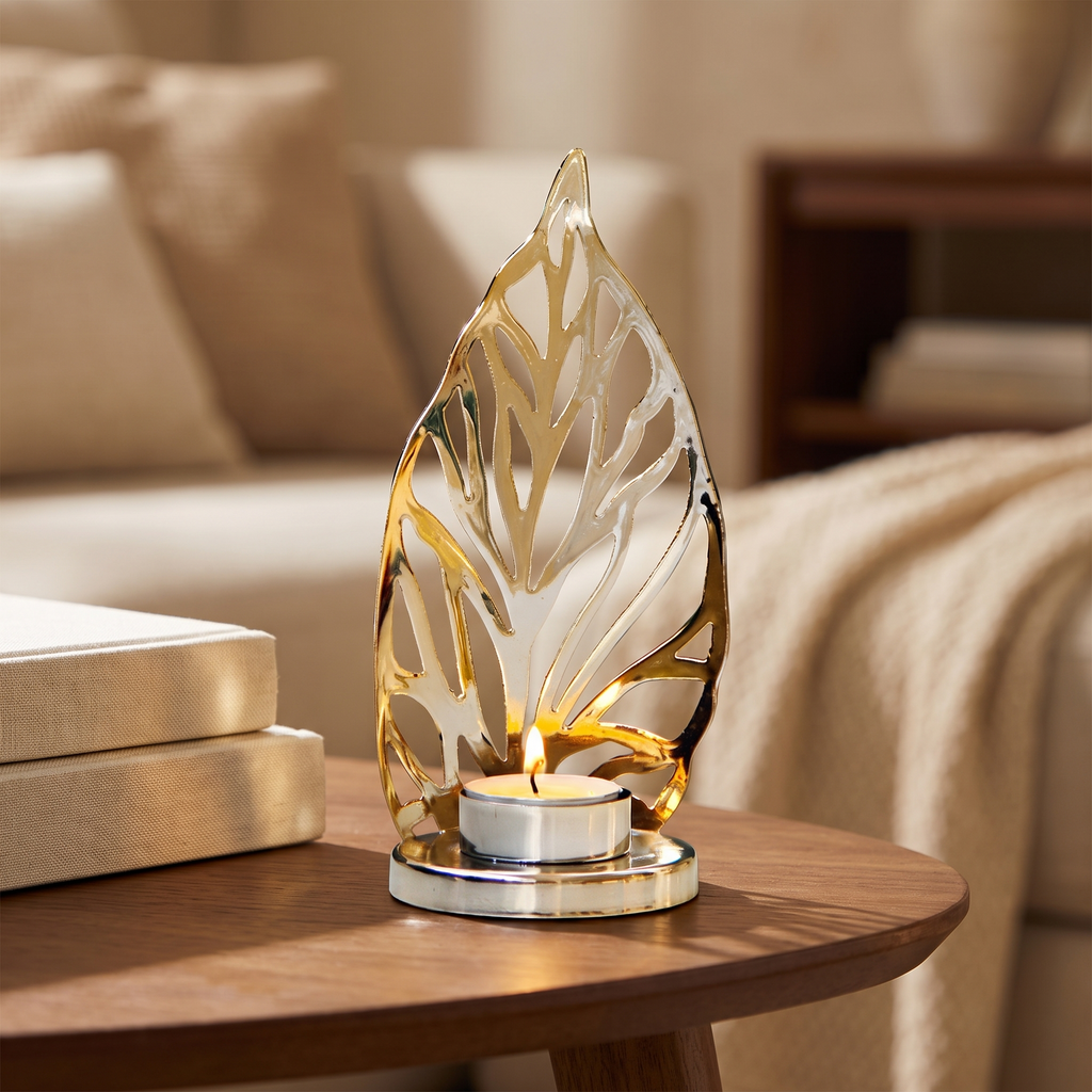 Gold leaf tealight holder with a lit tealight on a walnut side table