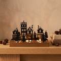 Small Christmas village tealight holder with reindeer on an oak mantel
